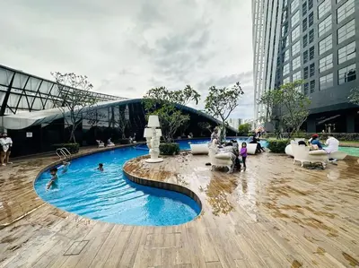 a swimming pool in a city with people in it at Diamond Home Comfort @ Arte Mont Kiara in Kuala Lumpur