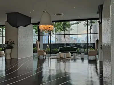 a living room with a couch and chairs and a chandelier at ARTE Mont Kiara Host By HOST CORNER SUITES in Kuala Lumpur