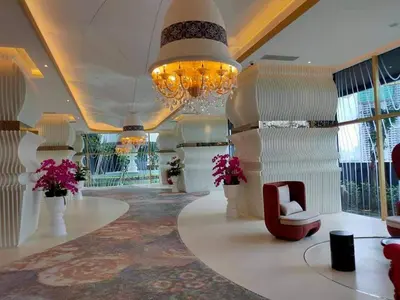 a large lobby with a chandelier and a chair at ARTE Mont Kiara Host By HOST CORNER SUITES in Kuala Lumpur