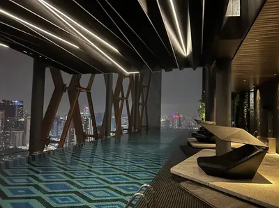 a building with a pool on the top of it at Luxury Scarletz Suite KLCC in Kuala Lumpur