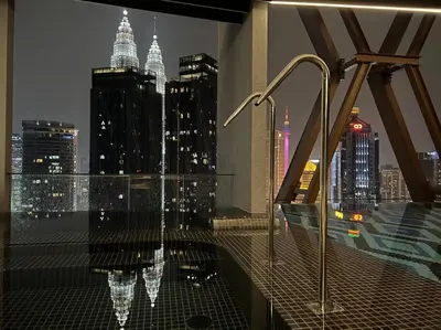 a bathroom with a view of a city at night at Luxury Scarletz Suite KLCC in Kuala Lumpur