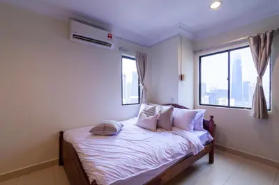 a bedroom with a bed with pillows and a window at Angkasa Impian 1 @ Bukit Bintang in Kuala Lumpur