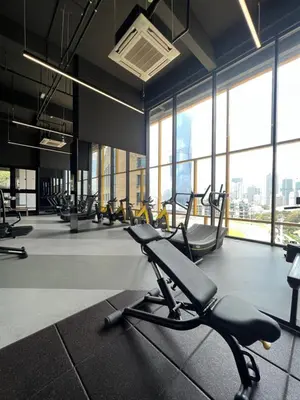 a gym with a row of chairs in a room with windows at Opus Residences KL 118 View in Kuala Lumpur