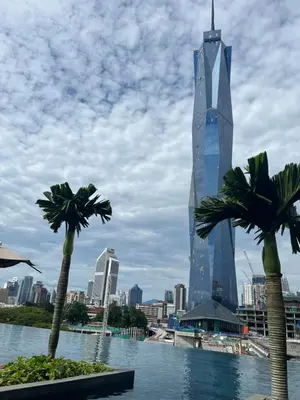 a view of a city with palm trees and a building at Opus Residences KL 118 View in Kuala Lumpur