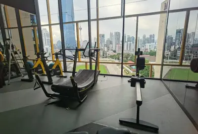 a gym with tread machines and a view of the city at Opus Residences KL 118 View in Kuala Lumpur