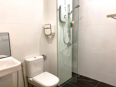 a bathroom with a shower and a toilet and a sink at Skyline Garden 2 Bedrooms Homestay Near KLCC in Kuala Lumpur