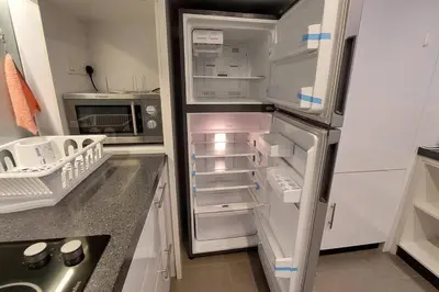 an empty refrigerator with its door open in a kitchen at KL Sentral, EST Bangsar #9, 4Pax in Kuala Lumpur