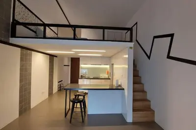 a kitchen with a table and a staircase in a house at KL Sentral, EST Bangsar #9, 4Pax in Kuala Lumpur