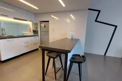 a kitchen with a table and two stools in it at KL Sentral, EST Bangsar #9, 4Pax in Kuala Lumpur