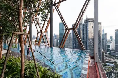 a swimming pool on the top of a skyscraper at KLCC ModernMusicalSuite AT ScarletzSuites in Kuala Lumpur