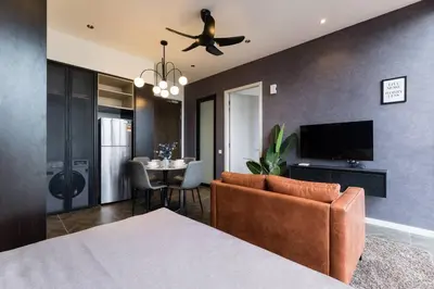 a bedroom with a bed and a dining room with a table at KLCC ModernMusicalSuite AT ScarletzSuites in Kuala Lumpur