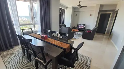 a dining room with a table and chairs and a living room at Homestay Jalan Tun Razak walking distance IJN, HKL, MRT Raja Uda, PUSRAWI, KPJ, PERKESO, Istana Budaya Гостевой дом Куала-Лумпур โฮมสเตย์ กัวลาลัมเปอร์ in Kuala Lumpur