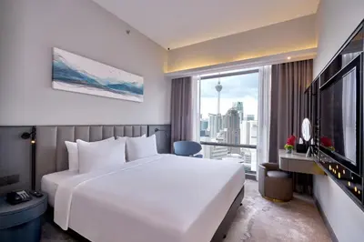 a bedroom with a large white bed and a large window at Sleeping Lion Suites in Kuala Lumpur