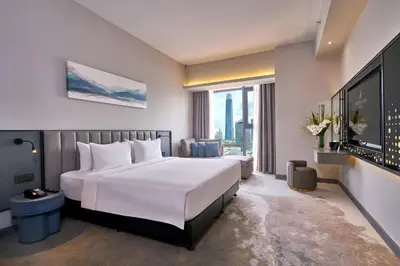 a hotel room with a bed and a large window at Sleeping Lion Suites in Kuala Lumpur