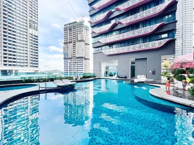 a large swimming pool in a city with tall buildings at Arte plus by Sweet home in Kuala Lumpur