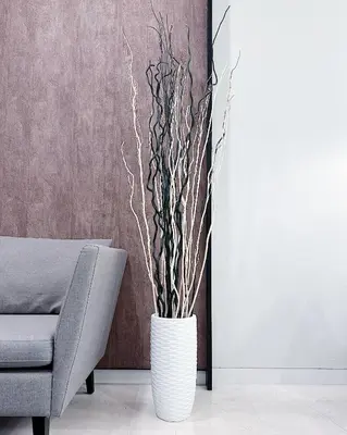 a white vase with branches in a living room at Tropicana The Residence suites by VV Homestay KLCC in Kuala Lumpur