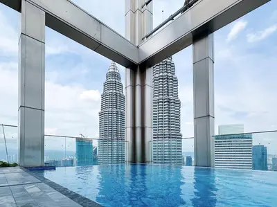 a pool on the top of a building with tall buildings at Tropicana The Residence suites by VV Homestay KLCC in Kuala Lumpur