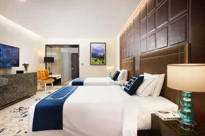 a hotel room with two beds and a desk at THE FACE Style Hotel in Kuala Lumpur