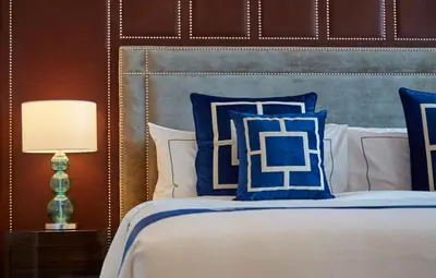 a bedroom with a bed with blue and white pillows at THE FACE Style Hotel in Kuala Lumpur