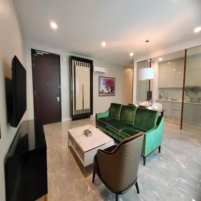 a living room with a green couch and a table at THE FACE Style Hotel in Kuala Lumpur