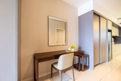 a dining room table with a chair and a mirror at Dorsett Residences Hartamas Kuala Lumpur by Feel Home in Kuala Lumpur