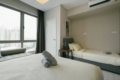 a hotel room with two beds and a window at Dorsett Residences Hartamas Kuala Lumpur by Feel Home in Kuala Lumpur