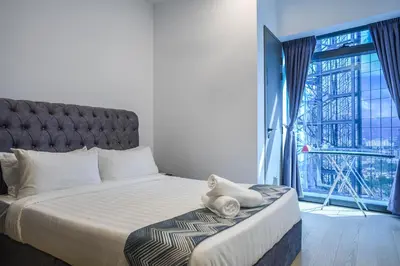 a bedroom with a large bed and a large window at Eaton Residence KLCC Skyline in Kuala Lumpur