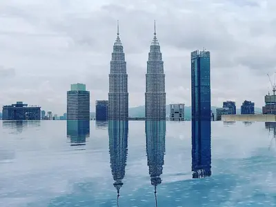 a view of the petronas twin towers reflecting in the water at Eaton Residence KLCC Skyline in Kuala Lumpur