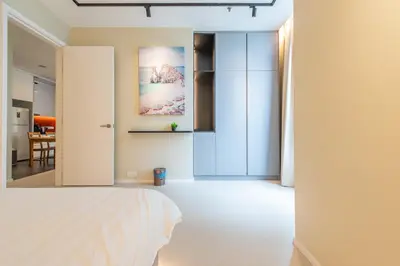 a bedroom with a white bed and a dining room at Arcoris Mont Kiara in Kuala Lumpur