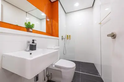 a bathroom with a sink and a toilet and a shower at Arcoris Mont Kiara in Kuala Lumpur