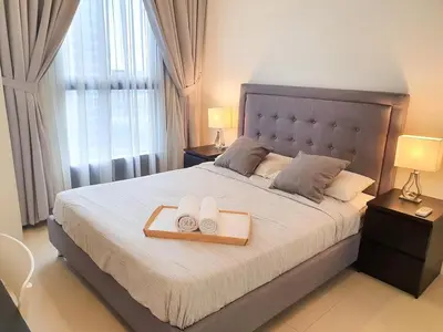 a bedroom with a large bed with two towels on it at Arcoris Mont Kiara Kuala Lumpur in Kuala Lumpur
