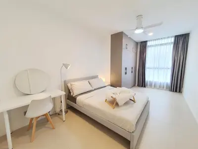 a bedroom with a bed and a desk and a mirror at Arcoris Mont Kiara Kuala Lumpur in Kuala Lumpur