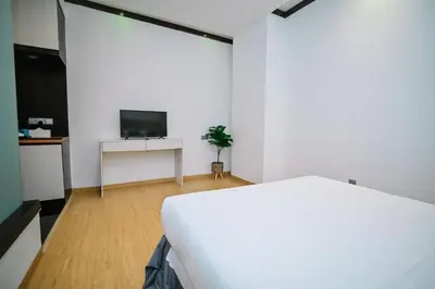 a white room with a bed and a tv at Kingston Hotel 5 - Chow Kit in Kuala Lumpur