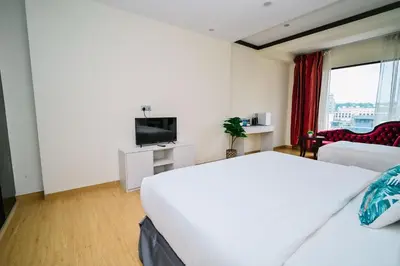 a hotel room with a bed and a flat screen tv at Kingston Hotel 5 - Chow Kit in Kuala Lumpur