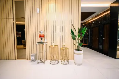 a lobby with two candles and a potted plant at Kingston Hotel 5 - Chow Kit in Kuala Lumpur