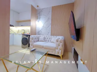 a living room with a white couch and a glass table at Arte Mont Kiara, Private Elegant Suite manage by Atlantis Management in Kuala Lumpur