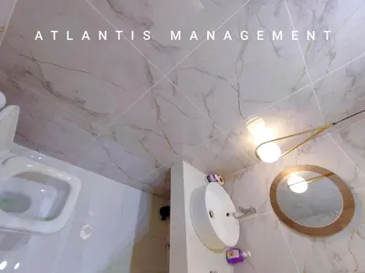 a bathroom with a sink and a toilet and a mirror at Arte Mont Kiara, Private Elegant Suite manage by Atlantis Management in Kuala Lumpur