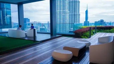 a lobby with a view of a city from a building at AXQUISITE SUITES at KLCC in Kuala Lumpur