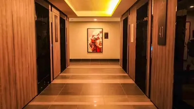 a hallway in a building with a painting on the wall at AXQUISITE SUITES at KLCC in Kuala Lumpur