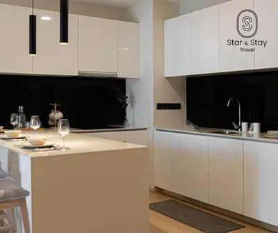 a kitchen with white cabinets and a counter top at AXQUISITE SUITES at KLCC in Kuala Lumpur