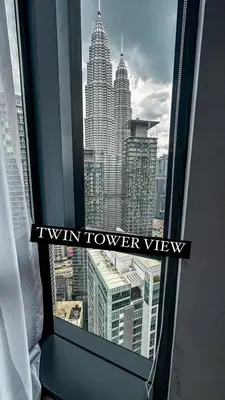 a window with a view of the kiwi tower view at AXQUISITE SUITES at KLCC in Kuala Lumpur