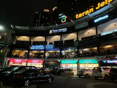 a parking lot with cars parked in front of a building at Superior Maya Kuala Lumpur in Kuala Lumpur