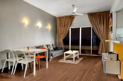 a living room with a table and a couch at Superior Maya Kuala Lumpur in Kuala Lumpur