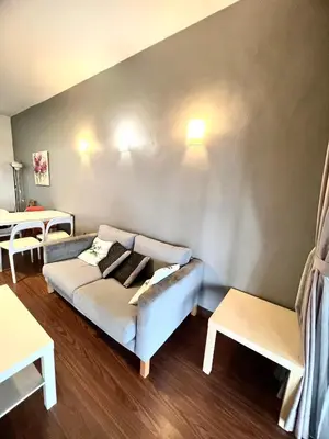 a living room with a couch and two tables at Superior Maya Kuala Lumpur in Kuala Lumpur