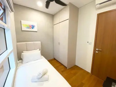 a small room with a bed and a door at Sky Suites KLCC by PNUT in Kuala Lumpur