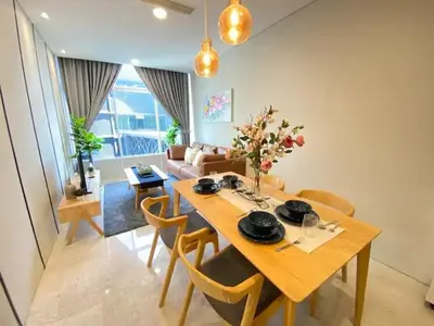 a dining room with a table and chairs and a couch at Sky Suites KLCC by PNUT in Kuala Lumpur