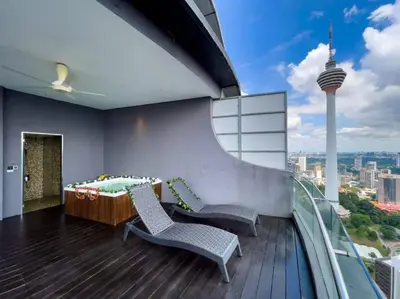 a balcony with two chairs and a table on a building at The Luxury Penthouses KLCC Petronas Twin tower Kuala Lumpur in Kuala Lumpur
