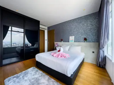 a bedroom with a bed with a pink dress on it at The Luxury Penthouses KLCC Petronas Twin tower Kuala Lumpur in Kuala Lumpur