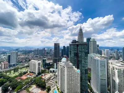 an aerial view of a city with tall buildings at The Luxury Penthouses KLCC Petronas Twin tower Kuala Lumpur in Kuala Lumpur