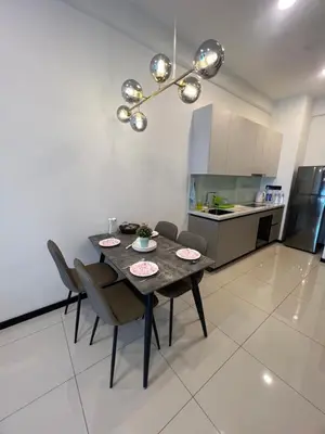 a dining room table and chairs in a kitchen at Opus Residences KL Malaysia in Kuala Lumpur